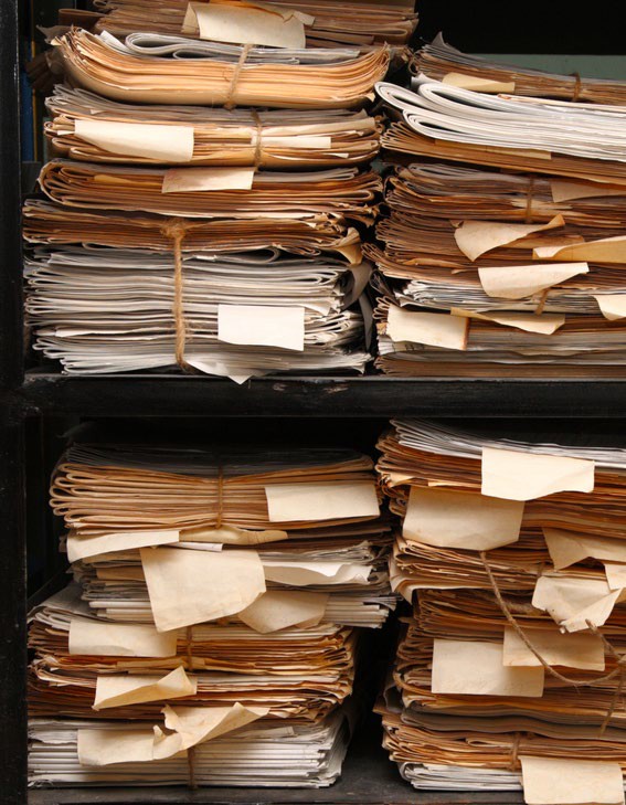 Stacks of paper manifests and files in storage